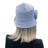 Eleanor narrow brim Pale blue linen with chiffon rose brooch Boston Millinery  rear view