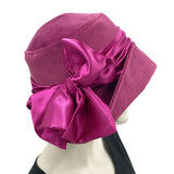 Vintage inspired 1920s style cloche hat handmade in raspberry velvet with a satin band and bow Boston Millinery made in the USA side bow view