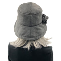 Eleanor cloche hat with equidistant brim handmade in gray  fleece and modeled on a mannequin  rear view