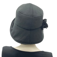 Eleanor cloche hat with equidistant brim handmade in black fleece and modeled on a mannequin  rear view