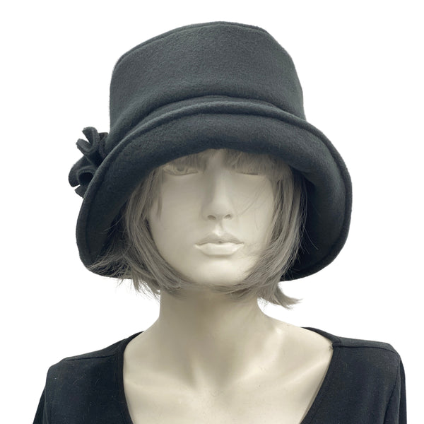 Eleanor cloche hat with equidistant brim handmade in black fleece and modeled on a mannequin 