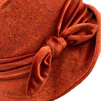 20s cloche hat in burnt orange wool with velvet band and bow texture close up