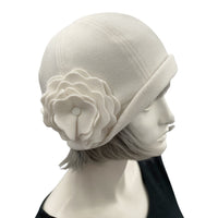 1930s Cloche Hat for Women modeled on a hat mannequin. Handmade in warm Fleece Hat. Winter wHite/cream with Large Flower Brooch, Satin Lined Winter Hat, Handmade in USA Boston Millinery. Side flower view 