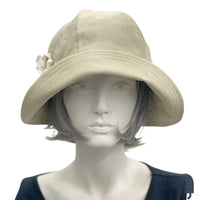 Polly wide front brim beige ,linen cloche hat with ribbon flower and button brooch  front view