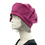 Raspberry velvet beret with bow modelled on a mannequin plain side view 