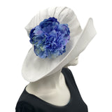 White Linen derby hat for women with blue peony style brooch modeled on a hat mannequin Boston Millinery USA