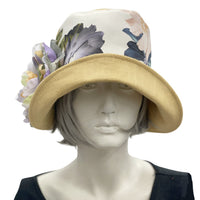 Yellow linen  Eleanor with wide front brim cloche  hat with floral band and large flower brooch front view  Boston Millinery 