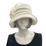 Boston Millinery's handmade winter white cream fleece 1920s style cloche hat for women, shown here on a hat mannequin . Front view of hat 