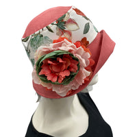 Eleanor cloche hat with a wide front brim for women handmade in dusky coral linen and a floral cotton accent band finished with a coral green and white peony flower brooch  - Side view of the flower brooch 