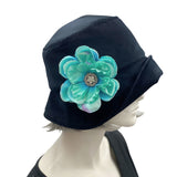 1920s Cloche Hat, Winter Hat Women, Black Velvet Hat with Turquoise and Rhinestone Peony Flower Brooch, Handmade in USA.Front view modeled on a hat mannequin head