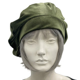 Sage green velvet beret shown modeled on a hat mannequin front  view handmade by Boston Millinery 