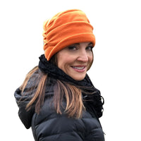 Burnt Orange Fleece Beanie lined in satin shown on a model 