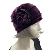 Velvet Cloche Hat and Chemo Headwear in Eggplant with Satin Flower Embellishment modeled on a hat mannequin side view with flower 