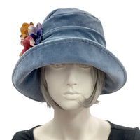 Boston Millinery's handmade Alice cloche in soft blue heavy velvet with contrasting hydrangea brooch modeled on a hat mannequin front view