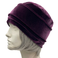 Velvet Cloche Hat and Chemo Headwear in Eggplant with Satin Flower Embellishment modeled on a hat mannequin plain side view 