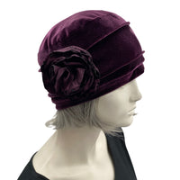 Velvet Cloche Hat and Chemo Headwear in Eggplant with Satin Flower Embellishment modeled on a hat mannequin side view with flower