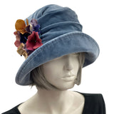 Boston Millinery's handmade Alice cloche in soft blue heavy velvet with contrasting hydrangea brooch modeled on a hat mannequin side front view