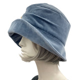 Boston Millinery's handmade Alice cloche in soft blue heavy velvet with contrasting hydrangea brooch modeled on a hat mannequin plain side view