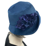 1920s Cloche Hat, Blue Velvet Hat with Hydrangea Flower Brooch, Handmade in the USA, Elegant Formal Headwearmodeled on hat mannequin, side view 