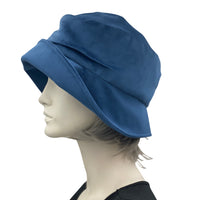 1920s Cloche Hat, Blue velvet with peony brooch modeled on a hat mannequin plain side view 