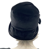 1920s style cloche hat for women in black velvet. Small brim hat with removable bow modeled on a hat mannequin rear view  Boston Millinery 