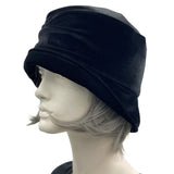 1920s style cloche hat for women in black velvet. Small brim hat with removable bow modeled on a hat mannequin side view  Boston Millinery 