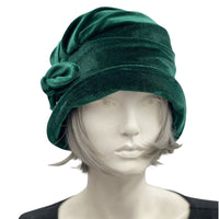 1920s style cloche hat for women in green velvet. Small brim hat with removable bow modeled on a hat mannequin front view  Boston Millinery 