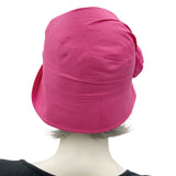 Very lightweight cotton cloche hat in magenta pink with satin flower brooch shown modeled on a hat  mannequin, handmade Boston Millinery, rear view