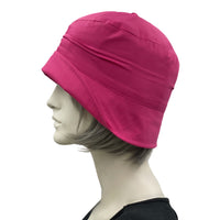 Very lightweight cotton cloche hat in magenta pink with satin flower brooch shown modeled on a hat  mannequin, handmade Boston Millinery, plain side view