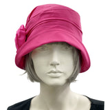 Very lightweight cotton cloche hat in magenta pink with satin flower brooch shown modeled on a hat  mannequin, handmade Boston Millinery, front view
